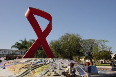 Taking a rest in front of a giant Aids ribbon.