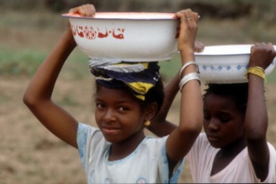 Girls transport water in Guinea.