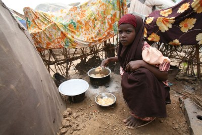 A girl cooking outside Sheikh Omar IDP camp in Jowhar, Somalia, September 2007(file pfoto).