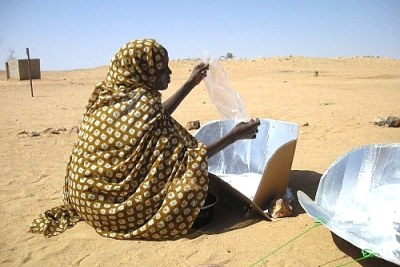 File photo: Woman in a refugee camp in Chad with solar cooker.