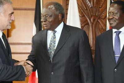 President Mwai Kibaki welcomes the International Criminal Court's chief prosecutor, Luis Moreno Ocampo, in Nairobi as Prime Minister Raila Odinga looks on.