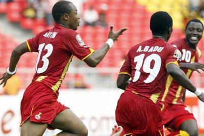 Andre Ayew, 13 at left, celebrates a goal.