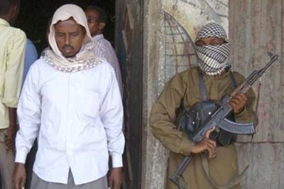 Al Shabaab men stand guard outside a retail store in Mogadishu.