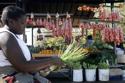 A woman sells vegetables at a food market in Harare,Zimbabwe.