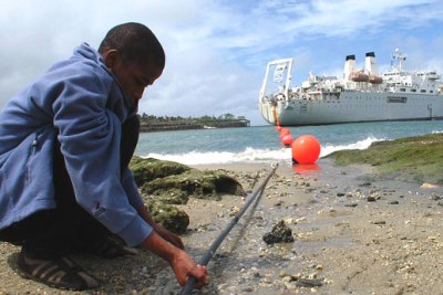 A boy holds the Kenyan Seacom cable (file photo): Despite wanting to link its ICT network to Kenya's submarine cables, the country is installing the incorrect fibre optic cables, experts say.