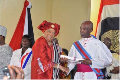 Sirleaf with Independence Day Orator Father Tikpor.