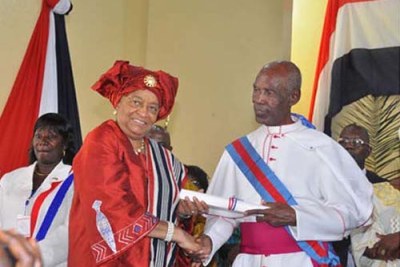 Pres. Ellen Johnson Sirleaf with Independence Day Orator Father Tikpor