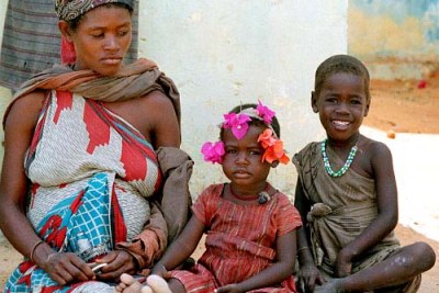 A Somali mother and two children waiting for food at a feeding centre in Mogadishu.