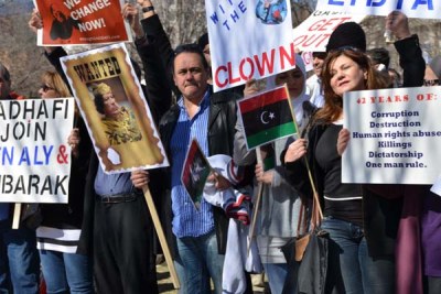 Cheerful and serious by turns, hundreds of people marched outside the White House in Washington D.C. as violence mounted in Libya.