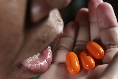 An Aids patient takes her daily dose of life-saving antiretroviral drugs (file photo).