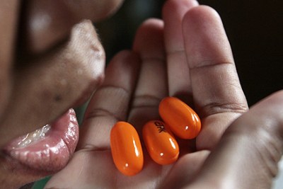 An Aids patient takes her daily dose of life-saving anti-retroviral (ARV) drugs.