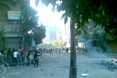 Protesters and police clash in the streets of Cairo.