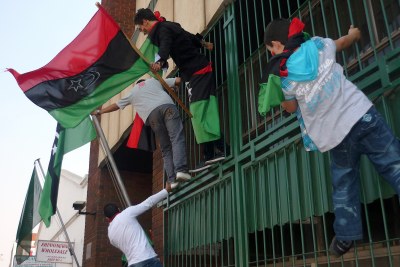 Libyans in Zimbabwe celebrate Muammar al-Gaddafi's fall. Harare, which backs Gaddafi, is considering expelling the Libyan ambassador after he defected to the opposition.
