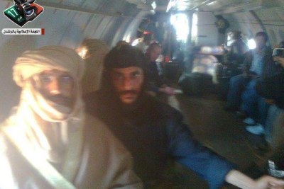This photo is purported to show Saif al Gaddafi, left, being flown to Zintan after his capture.