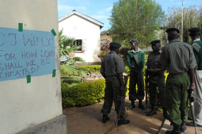 Writing on the wall: Prison warders stand beside a placard in the on-going lawyers strike in Bungoma.