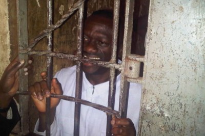Dr Besigye behind bars at Kiira Road Police Station.
