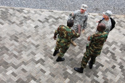 U.S. and Ghanaian soldiers discuss logistics for procuring and transporting medical equipment during a U.S. capacity building initiative .