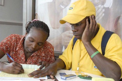 Mobile agent registers a client in Kampala (file photo).