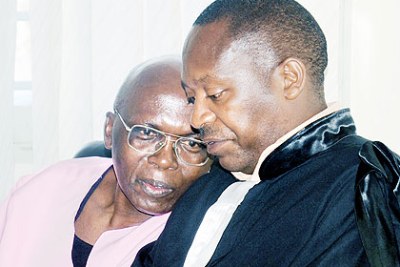 Genocide suspect Leon Mugesera (left) with his lawyer.
