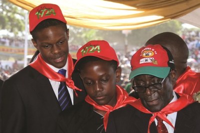 President Mugabe with his two sons (file photo).