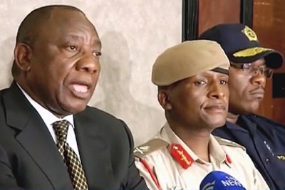 Facilitator Cyril Ramaphosa announces that rival security chiefs, Lieutenant General Tlali Kamoli of the Lesotho Defence Force, centre, and Police Commissioner Khothatso Tsooana, right, will both take a leave of absence.