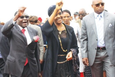 President Robert Mugabe and his wife greet supporters at the Harare international airport.
