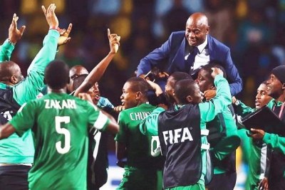 Emmanuel Amuneke celebrates with the Golden Eaglets players - most of whom are now part of the U-20 side that will face Burundi.