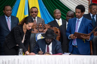 President Salva Kiir signing the peace deal in Juba