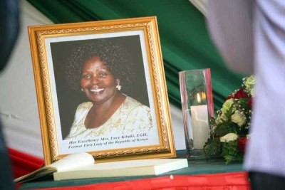A portrait of former First Lady Lucy Kibaki placed next to a condolence book at Harambee House in Nairobi on May 3, 2016. Former President Mwai Kibaki has thanked Kenyans for standing with his family as they mourn Mama Lucy.