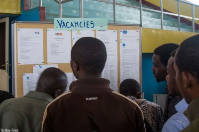 Jobseekers look for job opportunities on a notice board displayed at the Third Kigali Employment Fair at Petit Stade in Kigali.