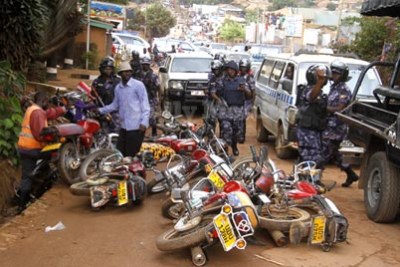 Police officers caning supporters of Opposition leader Kizza Besigye.