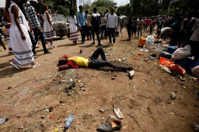 An injured protester waits for help after several people died during the Irrechaa, the thanks giving festival of the Oromo people in Bishoftu town of Oromia region.