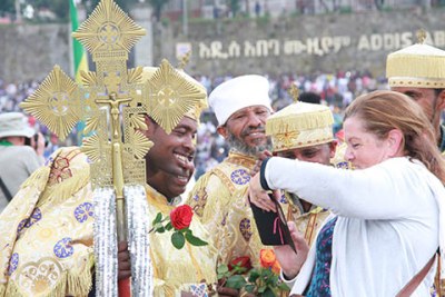 Mesqel (Meskel), or the Finding of the True Cross, is one of Ethiopia’s most awe inspiring spectacles, attracting tourists from all over the world. Here, a female tourist shows a small group of priests a photo she has taken of them on her smartphone.