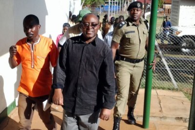 King Charles Mumbere being led to the courtroom where he was charged with murder in Jinja.