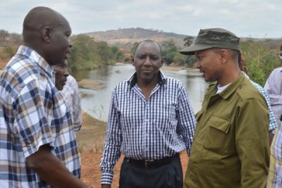 Then-Irrigation Principal Secretary Patrick Nduati (in cap) confers with government officials and residents at the site of the proposed Thwake multi-purpose dam.