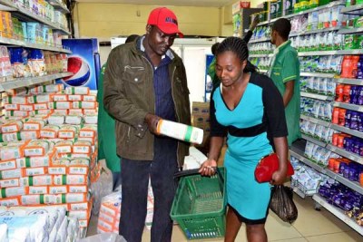 A couple at the Ronald Ngala branch of Tuskys Supermarket in Nairobi purchase a packet of maize flour on May 17, 2017.