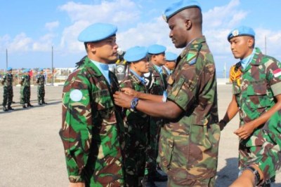 An Indonesian soldier receives an award from Lieutenant Colonel Shija Lupi of Tanzania during a ceremony held at Camp Soedirman Square on October 24, 2016. Lupi was a member of the UN Interim Force deployed in Lebanon.