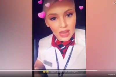 A woman wearing a British Airways flight attendant's uniform seen making racist comments about Nigerians.
