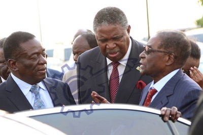 President Mugabe talks to Vice Presidents Emmerson Mnangagwa and Phelekezela Mphoko at Harare International Airport.