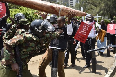 Activist Boniface Mwangi carrying a dummy bullet labelled #StopKillingUs (file photo).