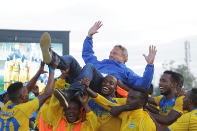 Rwanda Football team players lift up head coach Antoine Hey after 0-0 draw at Kigali stadium yesterday.