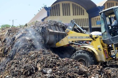 A Mombasa County bulldozer clears a heap of garbage at the Kongowea Market.