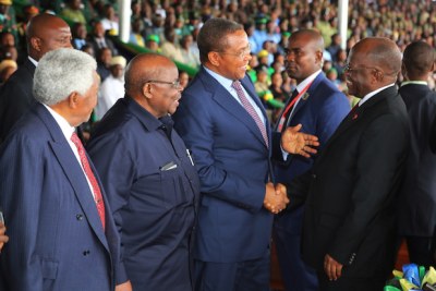 President John Magufuli shares a light moment with his predecessor Mr Jakaya Kikwete during the 56th Independence Day celebrations held at Jamhuri Stadium in Dodoma, yesterday. Looking on are former Presidents Benjamin Mkapa and Alhaj Ali Hassan Mwinyi (left)