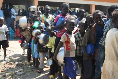 South Sudanese refugees queue for food after arriving at Rhino Settlement Camp in Arua District recently.