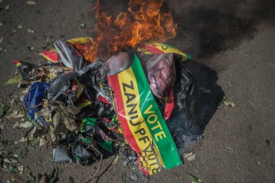 Protesters in Harare burnt ZANU-PF posters.