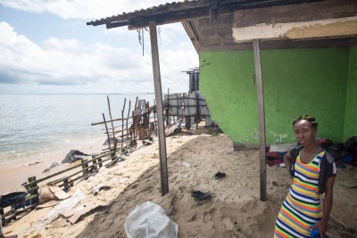 Gbeneweieh Quoh surveys what remains of her home at the edge of West Point township, Monrovia, Liberia, June 7, 2018.