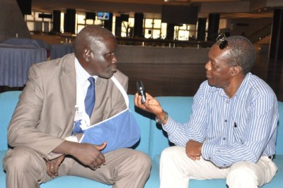 Aggrey Idris (arm in sling), interviewed by VOA's John Tanza Addis Ababa in 2015.