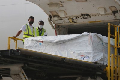 Staff unload the first shipment of Covid-19 vaccines distributed by COVAX at Kotoka International Airport in Accra, Ghana's capital.