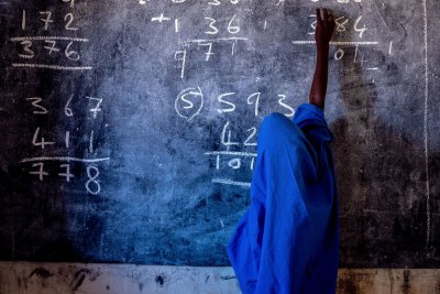 A young girl writes on a chalkboard at a primary school in Nigeria (file photo).