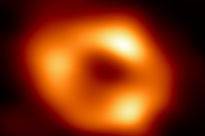 This is the first image of Sagittarius A* (or Sgr A* for short), the supermassive black hole at the centre of our galaxy. It’s the first direct visual evidence of the presence of this black hole. It was captured by the Event Horizon Telescope, an array which linked together eight existing radio observatories across the planet to form a single “Earth-sized” virtual telescope. The telescope is named after the “event horizon”, the boundary of the black hole beyond which no light can escape.